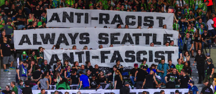 Seattle Sounders fans displaying banners: Anti-Racist, Always Seattle, Anti-Fascist