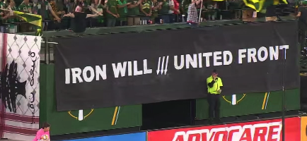 Soccer fans holding banner: Iron Will /// United Front